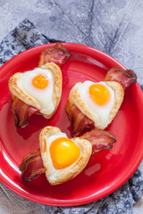 Baked egg breakfast with bacon heart shape for Valentine day