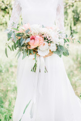 Beauty wedding bouquet in bride's hands