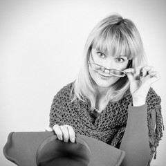 closeup portrait of a beautiful positive woman with stunning long hair blonde bright hat and knitted scarf. BW photo