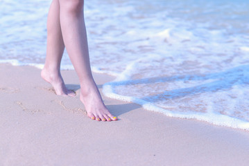beautiful leg girl a walking alone on the beach