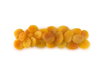 Heap of dried apricots isolated on white background. Dried fruit at border of image with copy space for text. Top view.