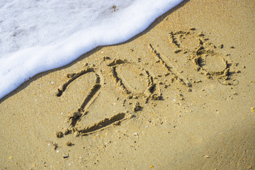 Abstract 2018 on a beach sand background