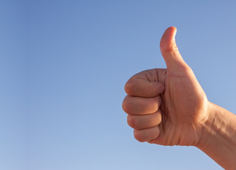 male hand showing thumbs up
