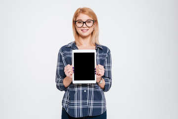 Pretty woman showing tablet display to camera