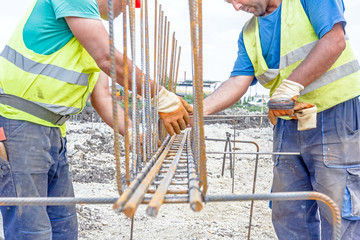 Construction worker binding rebar for reinforce concrete column