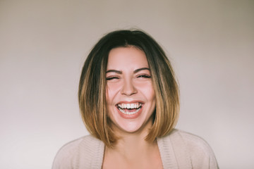 Fototapeta premium Frontal portrait of a beautiful joyful woman,laughing pretty women,head and shoulders portrait 