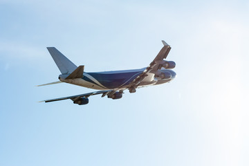 Transport airplane flying backlit