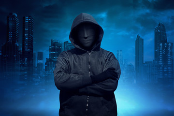 Hooded man with anonymous mask standing