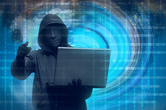 Hooded man with mask holding laptop