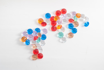 A collection of different faceted stones on a white background