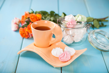 Romantic breakfast - zephyr, tea and roses on a table. Selective focus. Copy space.