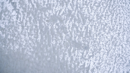 Texture of ice surface. Aerial view of frozen river from above with snow ornament