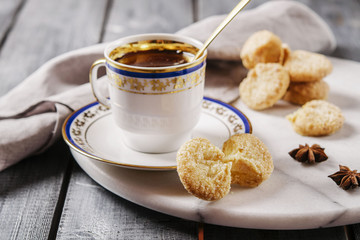 Cup of tea and cookies on a marble tray. Breakfast. Morning. Selective focus. Toned image 