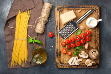 Raw Italian spaghetti with ingredients for cooking pasta