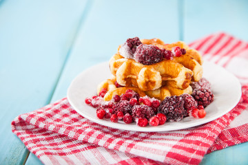 Belgian wafers with berries and ice cream in a plate, selective focus, copy space