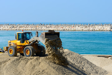 bulldozer working on a beach