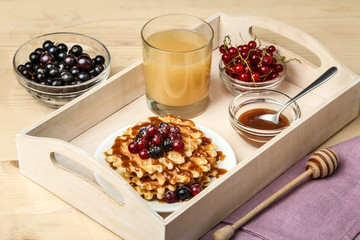 Baked waffles with fresh berries on the plate. Breakfast.