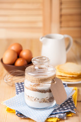 Сookies ingredients in a glass jar. Selective focus. Copy space