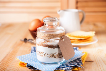 Сookies ingredients in a glass jar. Selective focus. Copy space