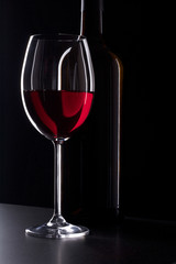 Glass of red wine in the dark