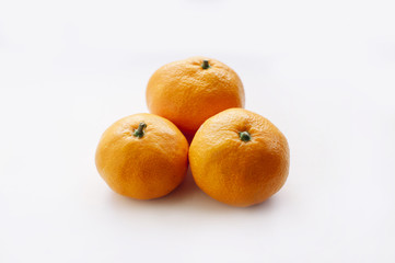 three delicious juicy tangerines on a white background