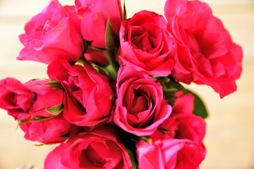 red roses on wooden table