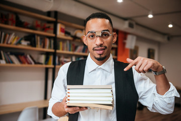 Handsome african businessman holding notebooks