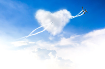 Love is in the two bird flying blue sky with hearts shape clouds