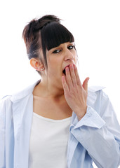 Yawning tired woman on white background