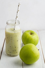 smoothies in the pot with straw and green apple