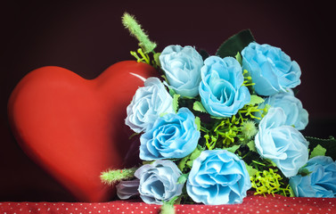 bouquet of blue roses and a large red heart