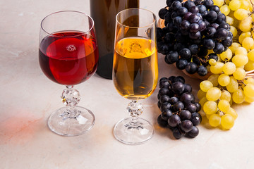 Wine and grapes. White and red wine in glasses and bottle of win
