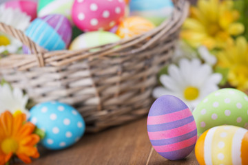 Obraz na płótnie Canvas Basket with colourful hand-painted Easter eggs