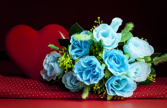 bouquet of blue roses and a large red heart