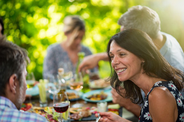 Group of friends lunching around a table on a terrace