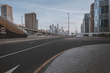 Dubai downtown in the evening, luxury modern buildings in bright yellow sunrise light, futuristic cityscape of United Arab Emirates.