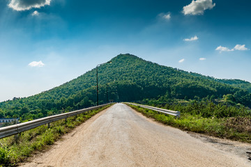 Dust road with mountain