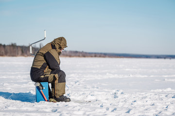Fototapeta na wymiar Winter fishing on lake.