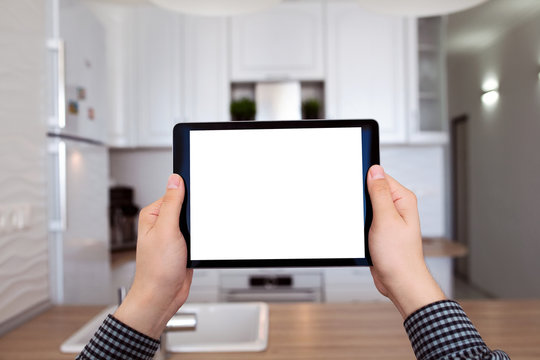 male hands holding tablet with isolated screen kitchen in house