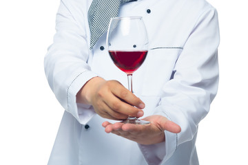 cook holds in the palm of a glass of red wine on a white background