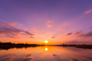 Sunset sky background with landscape of calm lake at sunset