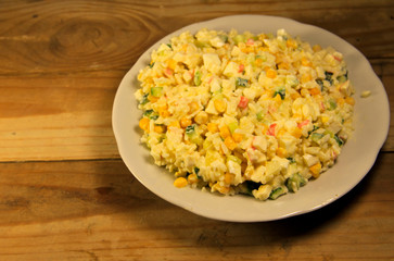 Salad with crab sticks sweet corn cucumber eggs and rice