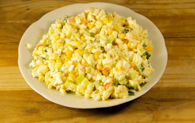 Salad with crab sticks sweet corn cucumber eggs and rice