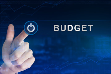 business hand clicking budget button