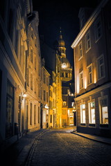 Fototapeta na wymiar Night in old Riga - famous European city where tourists can find a unique atmosphere of Middle Ages