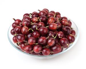Red gooseberry in glass bowl isolated on white background