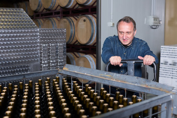 Smiling wine maker unloads containers