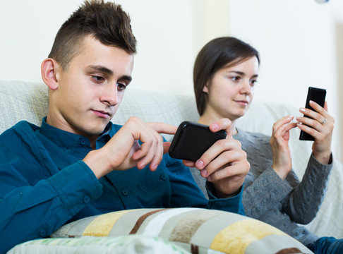  Brunette And Teenager Looking At Screens Of Smartphones