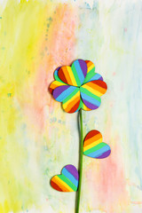 Rainbow painted hearts in flower shape on watercolor background