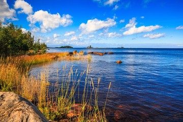 Fototapeta na wymiar Sunny lake landscape in rural Finland